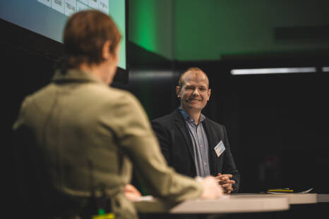 Municipal Development Director Albert Andersson at the Business Arena 2026 event, with another person in the background with their back to the camera.